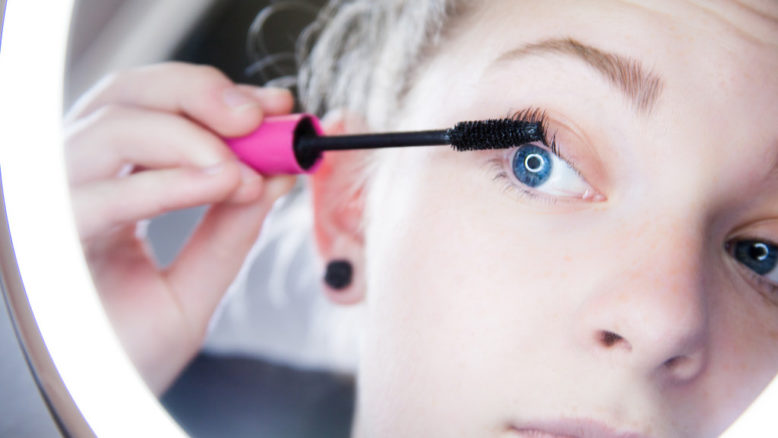 woman applying mascara